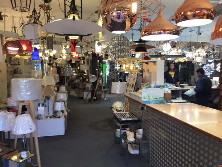 The showroom counter under a row of copper and black pendants