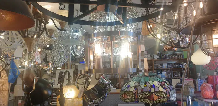 A ceiling of lit pendants and chandeliers in the Cosmo Lighting showroom