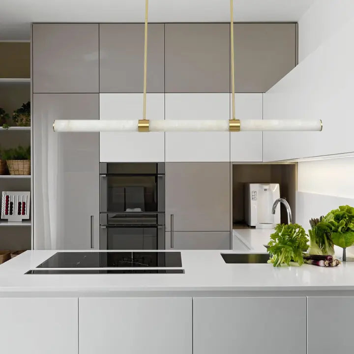 A linear LED pendant in brass and marble by Lighting Creations